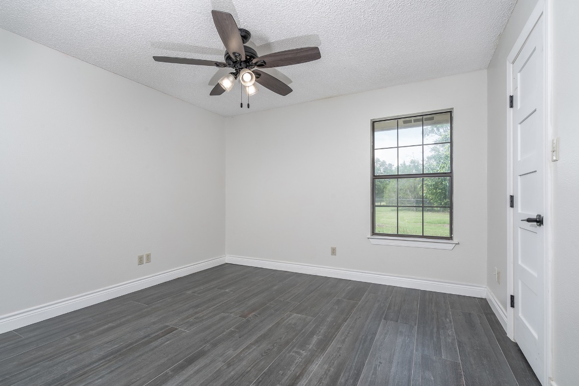 444 Logan Ranch Road Georgetown, TX 78628 - Photo 24 of 36 wooden floor in an empty room with a window