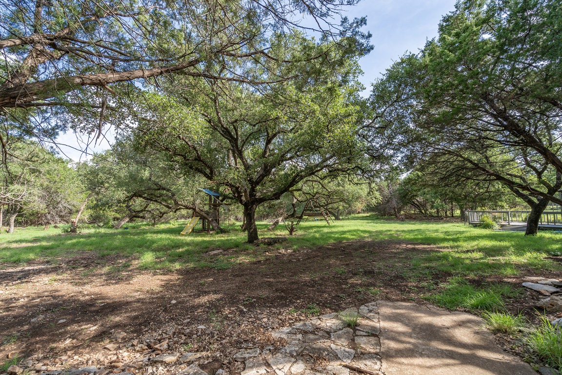 444 Logan Ranch Road Georgetown, TX 78628 - Photo 31 of 36 a view of a big yard with plants and large trees