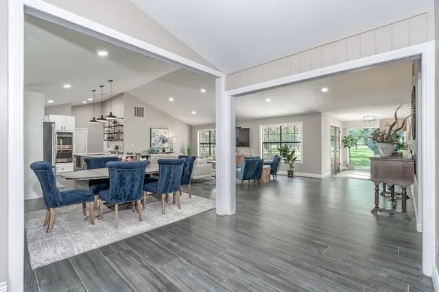 a view of a dining room and livingroom with lots of furniture