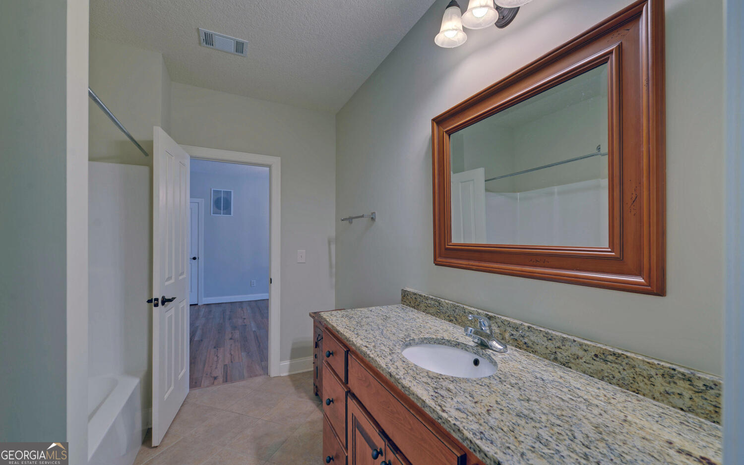60 Browns Lane Hartwell, GA 30643 - Photo 53 of 89 a bathroom with a granite countertop sink and a mirror