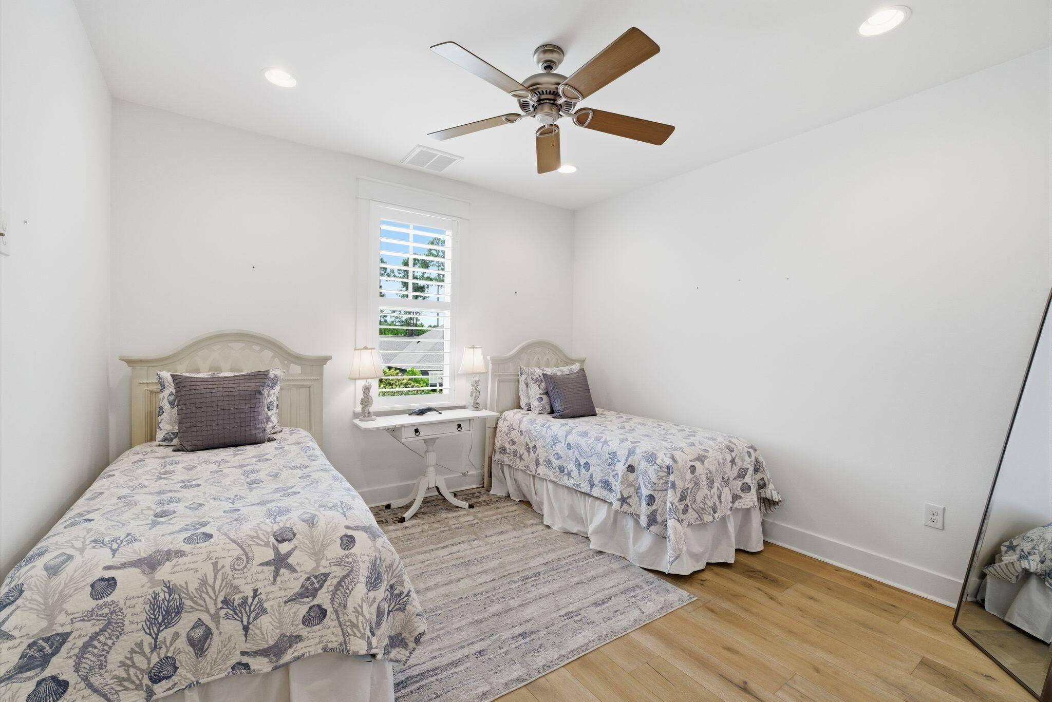 133 Sandchase Circle, Unit LOT 15 Inlet Beach, FL 32461 - Photo 25 of 47 a bedroom with a bed and a ceiling fan