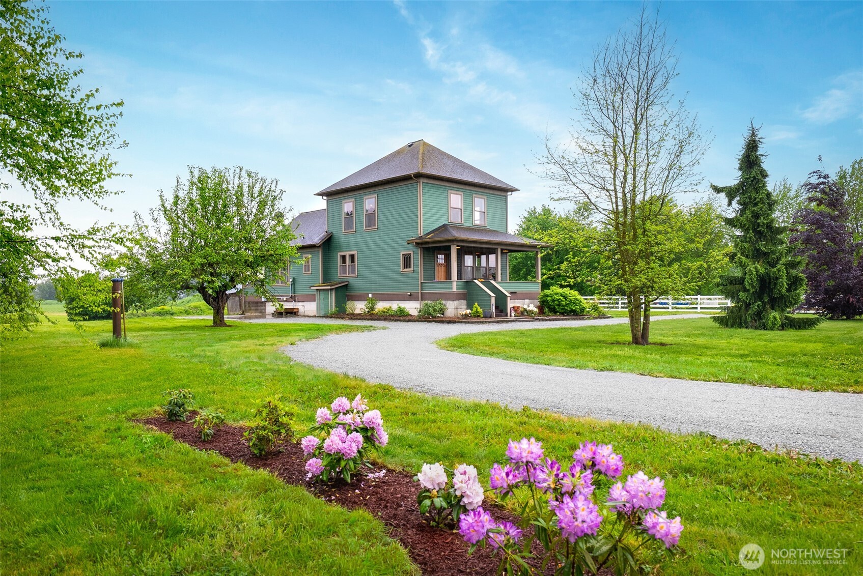 2304 Norman Road Stanwood, WA 98292 - Photo 2 of 39 a view of a house with a big yard and potted plants
