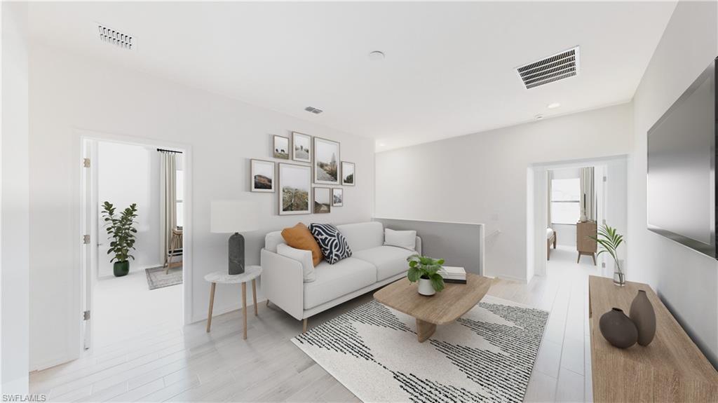 3038 Juniper Way Naples, FL 34112 - Photo 10 of 19 a living room with furniture and a wooden floor