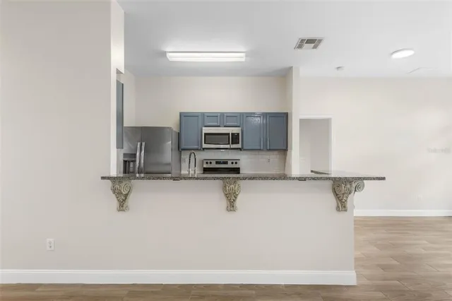 a kitchen with a sink cabinets and microwave