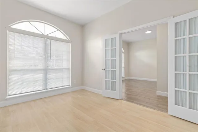 an empty room with windows and closet