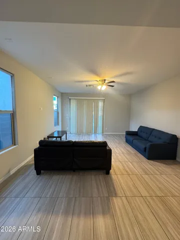 a spacious bedroom with a bed and wooden floor