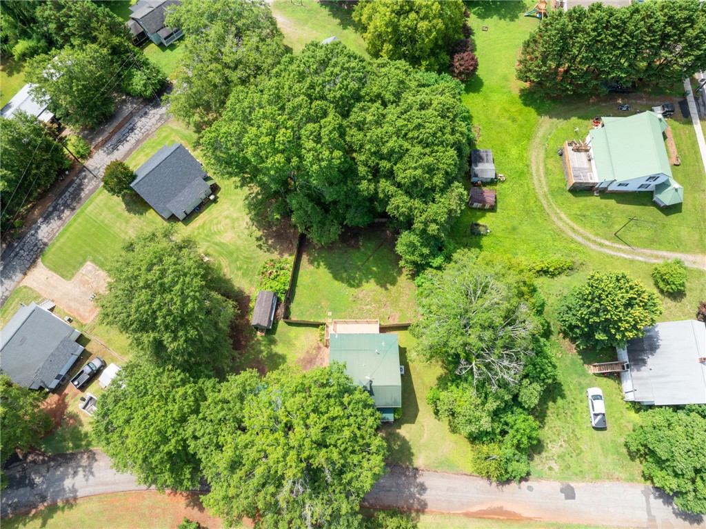 108 Tarrant Street Central, SC 29630 - Photo 37 of 42 An aerial perspective reveals a verdant landscape surrounding multiple residences, each nestled amidst mature trees and open green spaces.