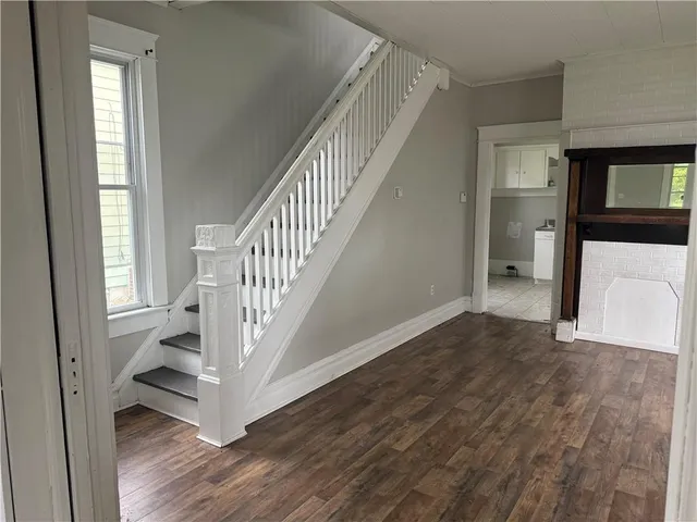 a view of entryway with wooden floor and stairs