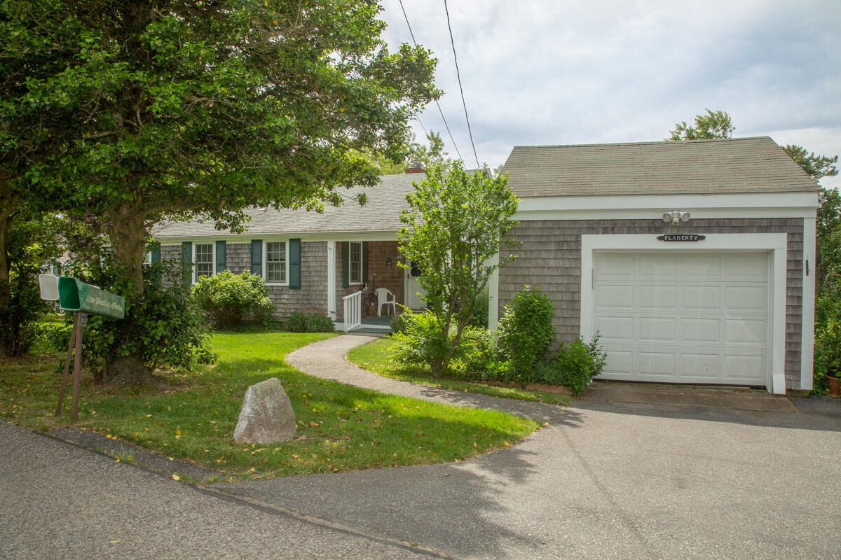 205 Stoney Point Road Cummaquid, MA 02675 - Photo 4 of 24 a view of a house with backyard and garden
