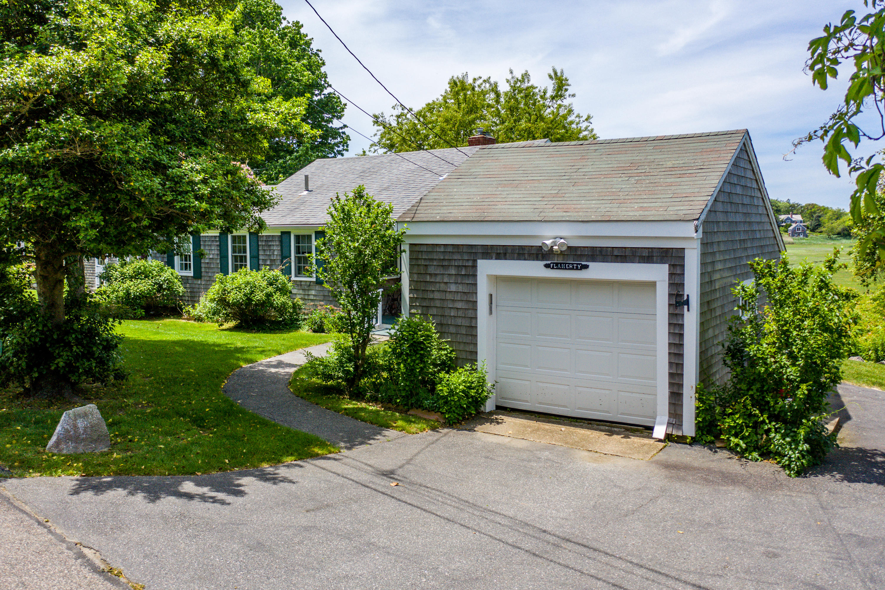 205 Stoney Point Road Cummaquid, MA 02675 - Photo 5 of 24 front view of a house with a yard