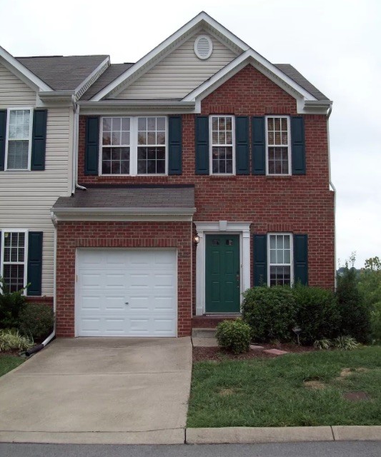 1345 Bell Road, Unit 312 Antioch, TN 37013 - Photo 1 of 7 a front view of a house with a yard and garage