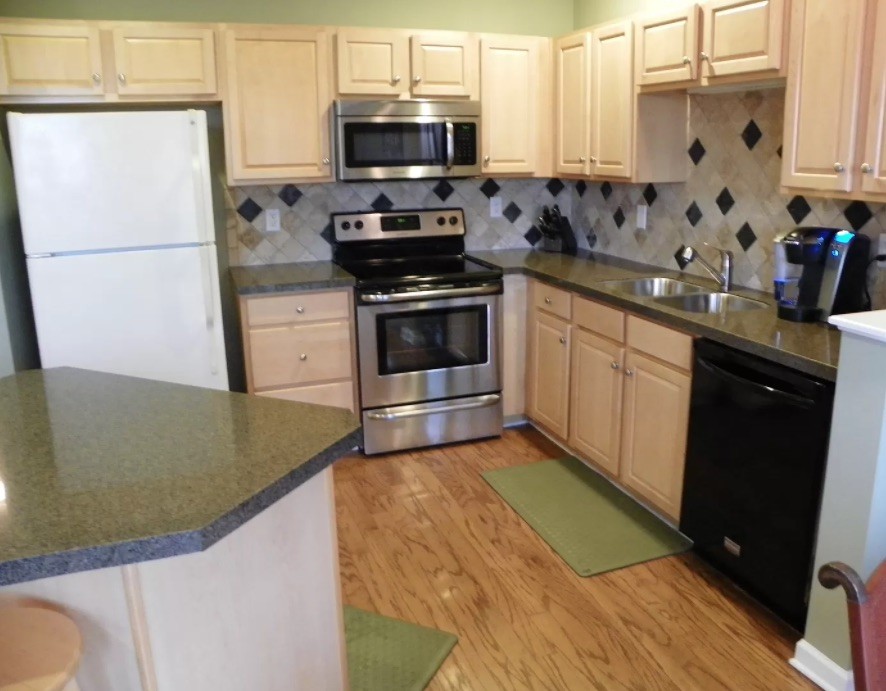 1345 Bell Road, Unit 312 Antioch, TN 37013 - Photo 3 of 7 a kitchen with stainless steel appliances granite countertop a stove a sink and a refrigerator