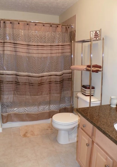 1345 Bell Road, Unit 312 Antioch, TN 37013 - Photo 6 of 7 a bathroom with a granite countertop sink toilet and a mirror