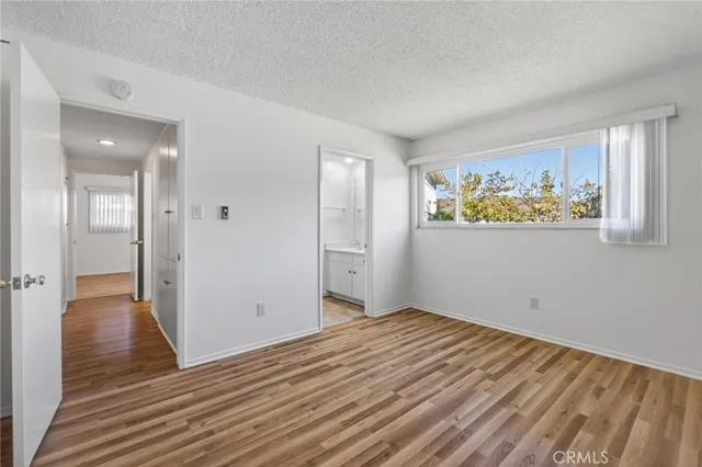 a view of a room with wooden floor and window