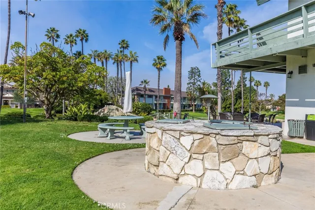 a view of a backyard with plants and outdoor seating