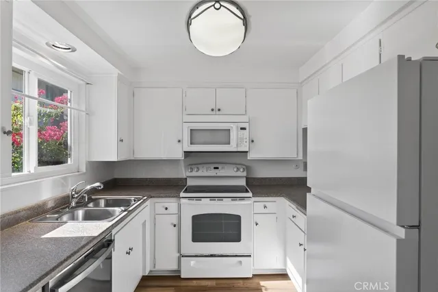 a kitchen with a stove cabinets and a sink
