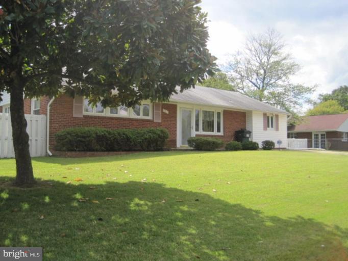 a front view of house with yard and trees