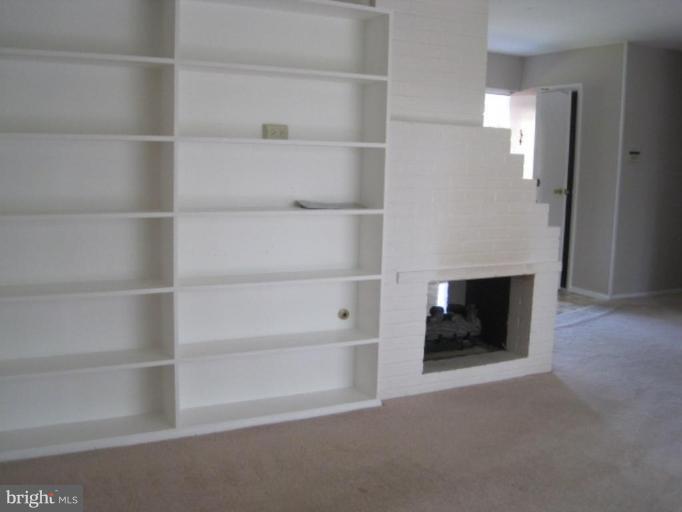 6621 Edsall Road Springfield, VA 22151 - Photo 4 of 5 a view of a room with walk in closet with empty racks