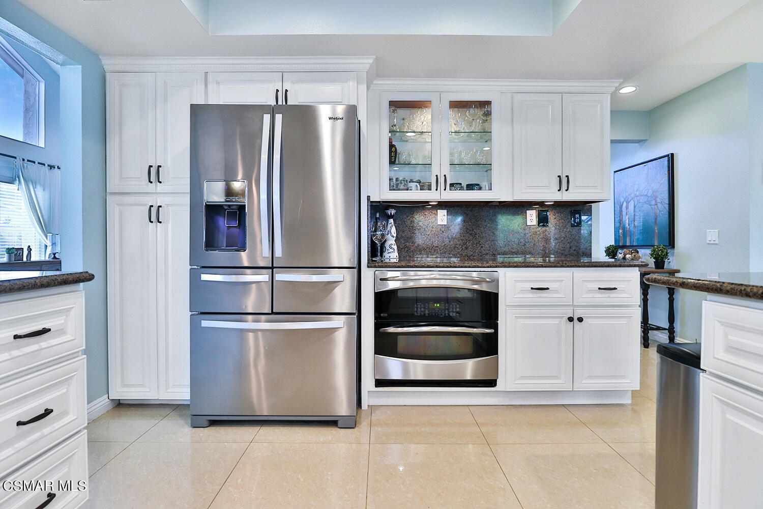3053 Bianca Circle Simi Valley, CA 93063 - Photo 23 of 73 a kitchen with white cabinets and stainless steel appliances