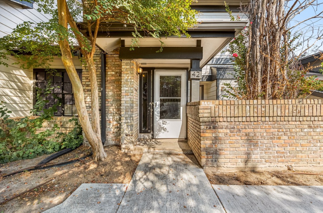 1748 Ohlen Road, Unit 42 Austin, TX 78757 - Photo 3 of 17 a front view of a house with a porch
