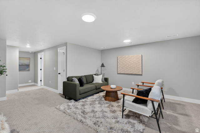 2841 West 2705 North, Unit 69 Ogden, UT 84404 - Photo 26 of 31 Spacious carpeted room featuring light gray walls, white trim, recessed lighting, and white paneled doors with black hardware