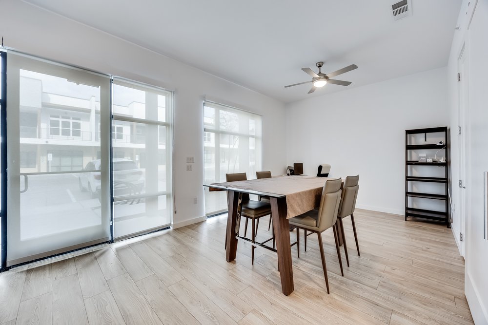 4801 Springdale Road, Unit 2107 Austin, TX 78723 - Photo 13 of 26 a dining room with furniture window and wooden floor