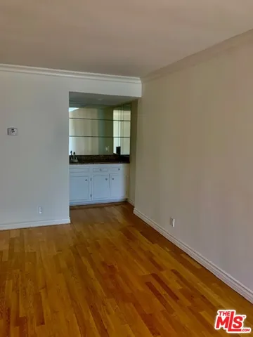 a view of an empty room and wooden floor