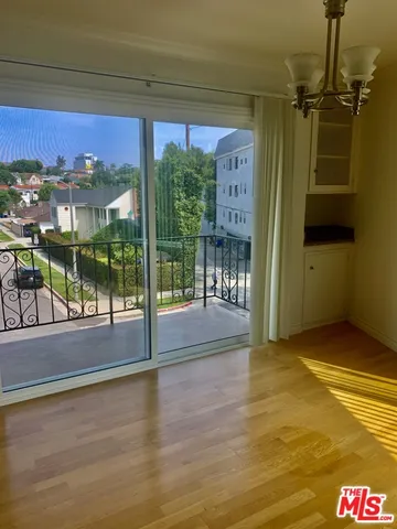 a view of a room with wooden floor and windows