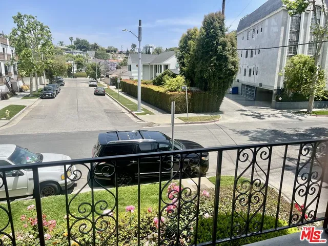 a view of a patio with table and chairs potted plants