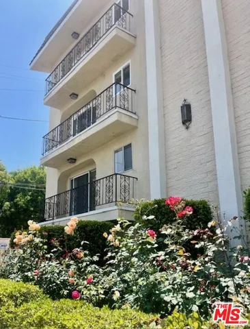 a flower garden is sitting in front of a house