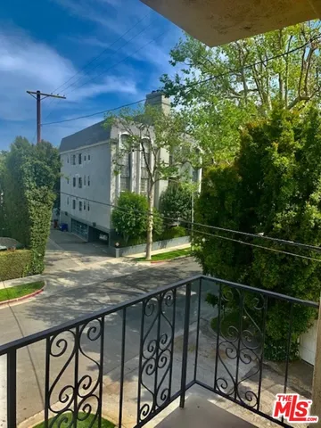 a view of a porch with a table and chair
