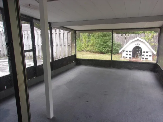 a view of empty room with large windows