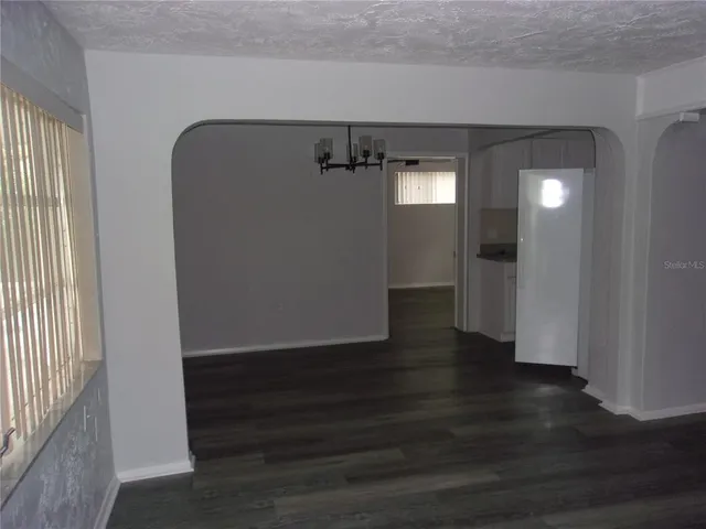 a view of a room with wooden floor