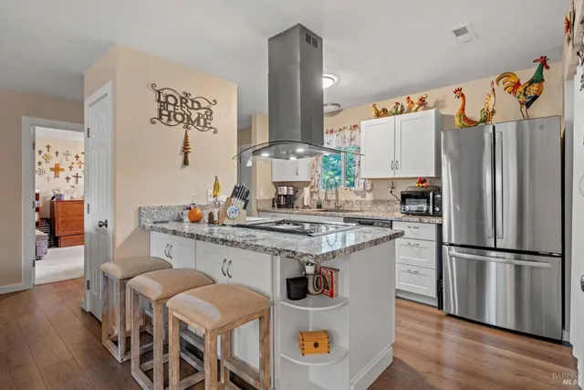 a kitchen with stainless steel appliances a stove a sink and a refrigerator