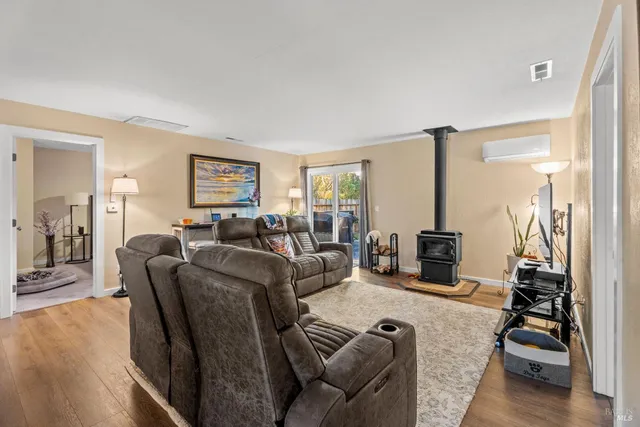 a living room with furniture a large window and a flat screen tv