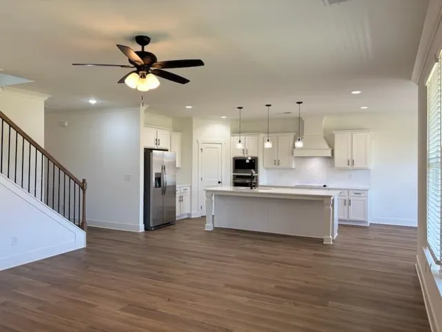 a view of kitchen with stainless steel appliances kitchen island a refrigerator sink and a stove