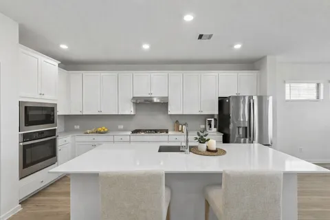 a kitchen with a sink a stove and refrigerator