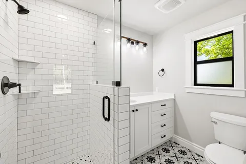 a bathroom with a sink toilet and shower