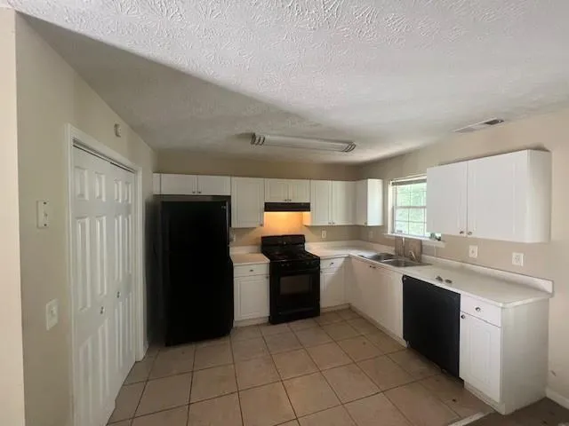a kitchen with a sink and a refrigerator