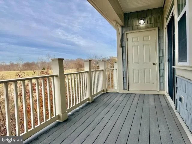 a view of a balcony with wooden floor