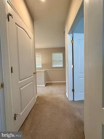 a view of a hallway to rooms