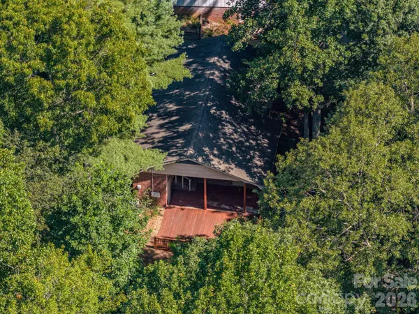 an aerial view of a house with a yard and outdoor space
