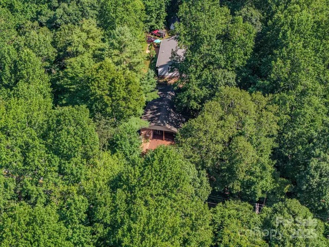 an aerial view of a house with a yard and outdoor space
