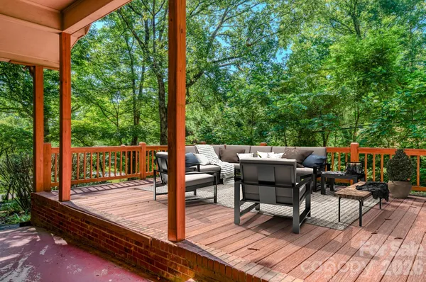 a view of a porch with wooden floor and fence