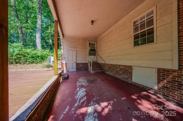 a view of a porch with wooden floor and fence
