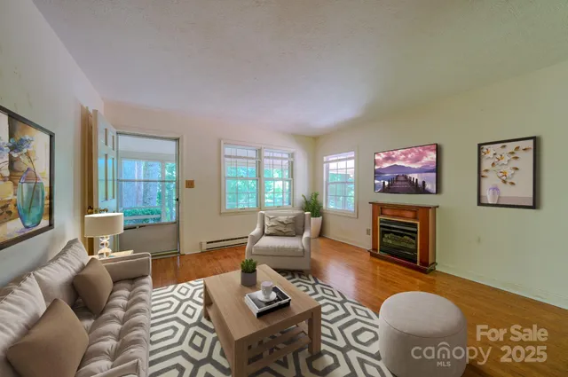 a living room with furniture a flat screen tv and a fireplace
