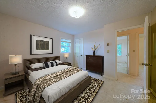 a bedroom with a bed and a lamp