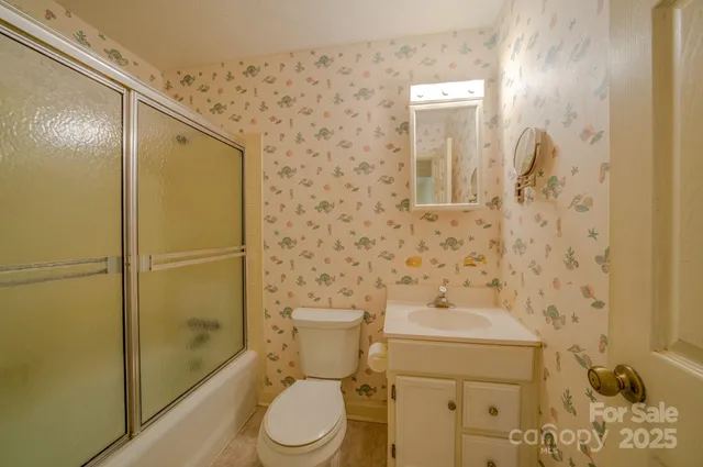 a bathroom with a toilet a sink and shower