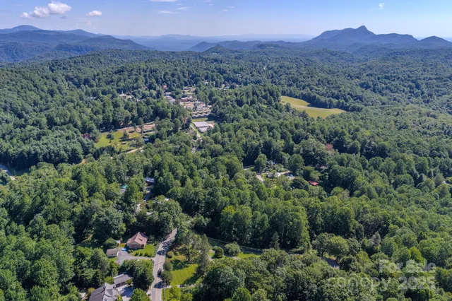 an aerial view of a residential house with mountain view