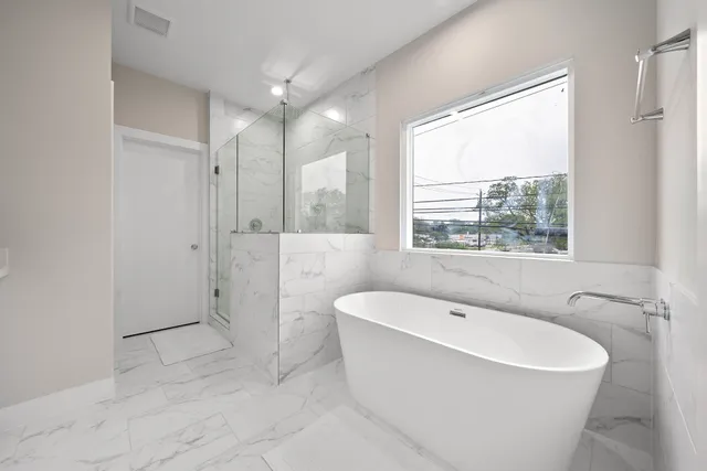 a bathroom with a bathtub and a shower